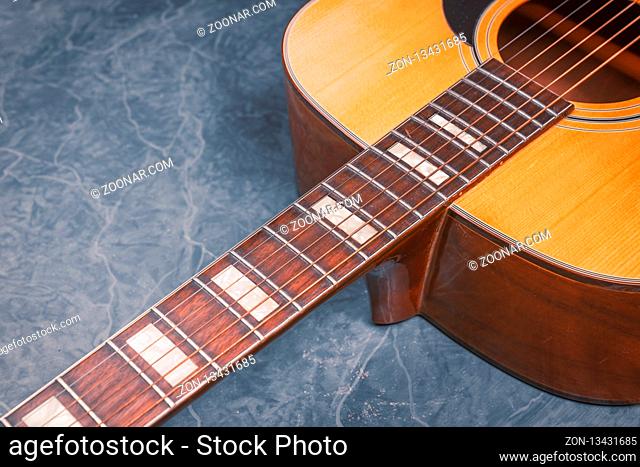 acoustic guitar on blue marble background, music concept