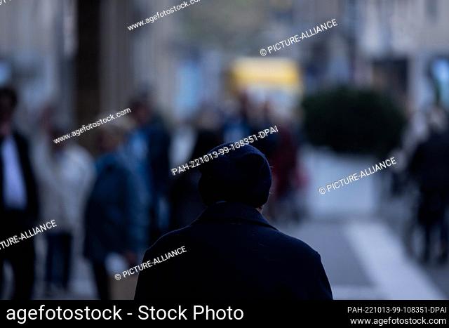 PRODUCTION - 11 October 2022, North Rhine-Westphalia, Duesseldorf: A person walks alone through the city center. The representative study ""The Fears of...