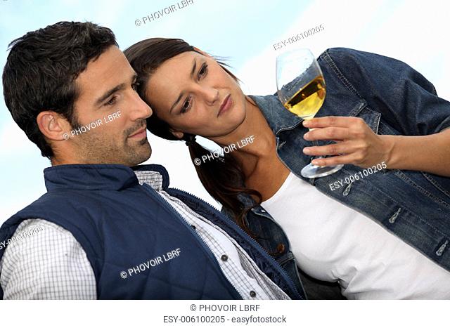 Couple looking at a glass of alcohol