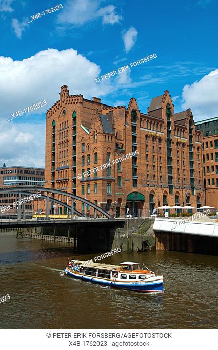 Sightseeing cruise boat along Magdeburger Hafen canal passing Maritime museum HafenCity the warehouse district old harbour area central Hamburg Germany Europe