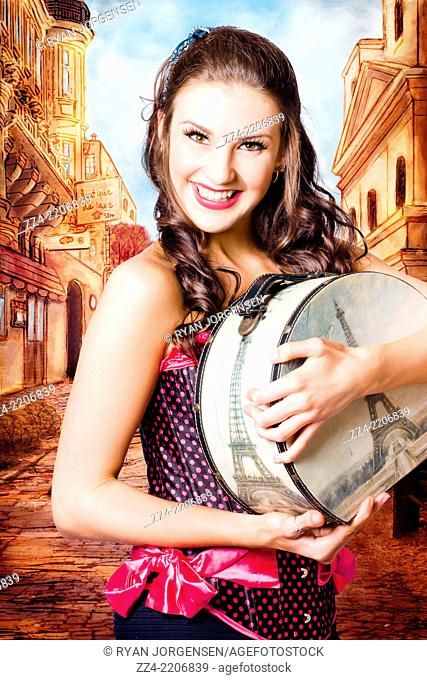 Fine art photo illustration of a beautiful brunette girl with smile holding travelling luggage on hand drawn European cobblestone street