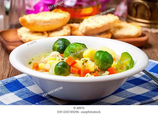 Bowl of minestrone soup on wooden table