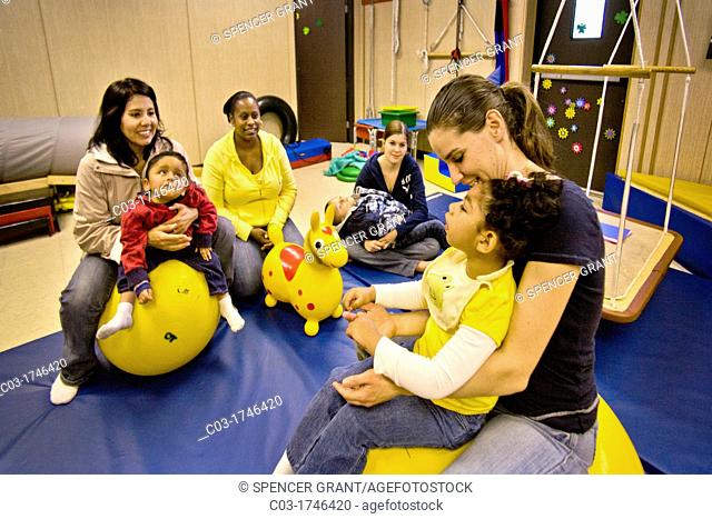 Teachers comfort disoriented vision-impaired children in a sensory motor group at the Blind Children's Learning Center in Santa Ana, CA