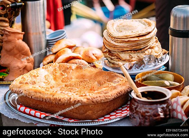 The dishes of the traditional Belarusian cuisine - pie, pancakes and honey