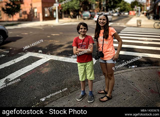 Myrtle Av/Broadway, New York City, NY, USA, 14 years old caucasian teenager girl and 12 years old caucasian teenager boy - both with brown hair and summer...
