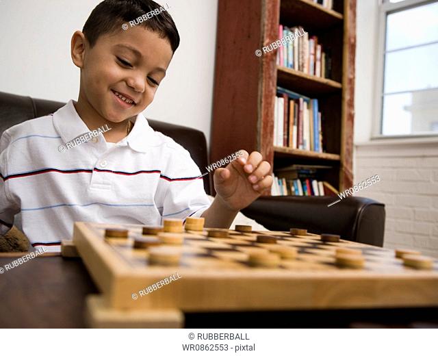 Young boy playing checkers