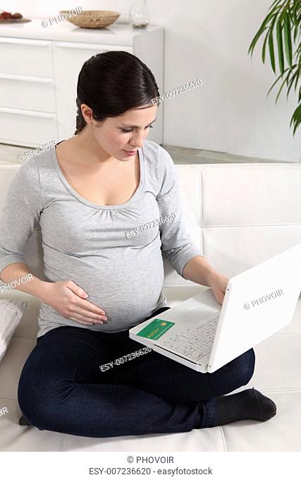 Pregnant woman at a laptop