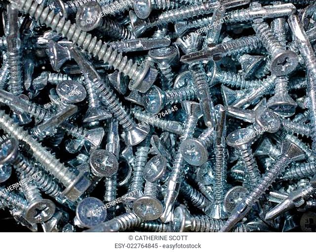 Background of screws - from building site so covered in dust