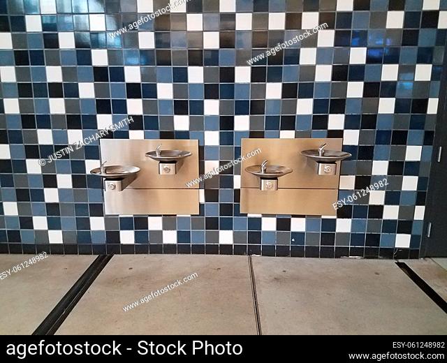 blue and white tiled wall and water fountains