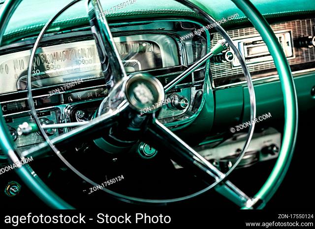 DIEDERSDORF, GERMANY - AUGUST 21, 2021: The dashboard of luxury car Cadillac Series 62 Coupe de Ville, 1953. Close-up. Focus on the background