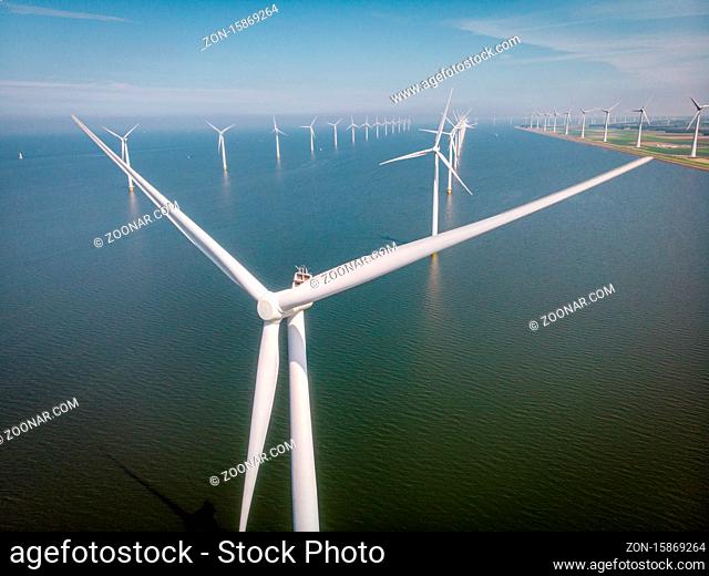 Windmill park westermeerdijk Netherlands, wind mill turbine with blue sky in ocean, green energy, global warming concept