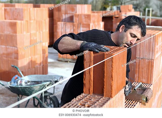 Worker building a wall