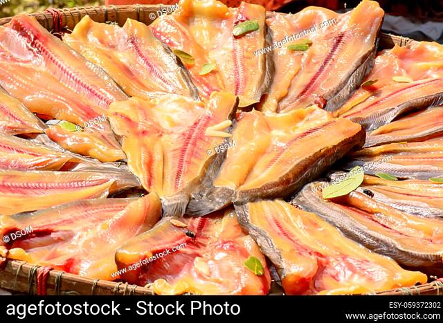 The striped snakehead fish drying in the sun for sale