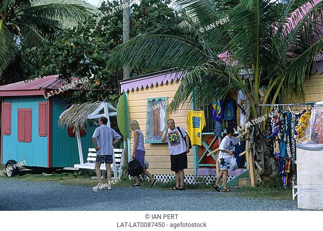 British Virgin Islands. Market. Road Town. Bright painted stalls, goods. People with shopping bags