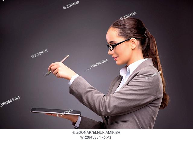 Businesswoman working on tablet computer in business concept