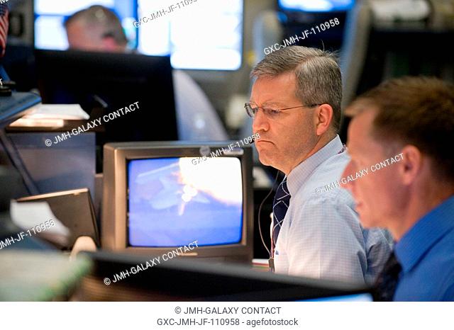 Astronauts Chris Ferguson (foreground) and Steve Frick, STS-129 spacecraft communicators (CAPCOM), are pictured at their console in the space shuttle flight...