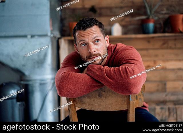 Thoughtful mature man sitting on chair