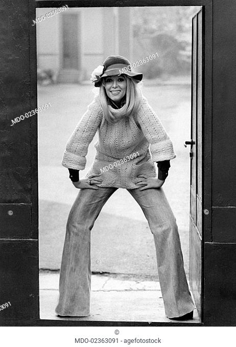 Italian actress and showgirl Isabella Biagini posing in a doorway. Milan, 1970s