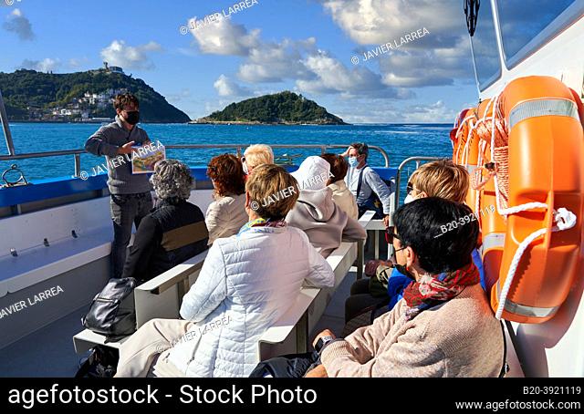 Tourist boat sailing through La Concha Bay, it is part of the excursion that takes place from Puerto Donostiarra to Santa Clara Island