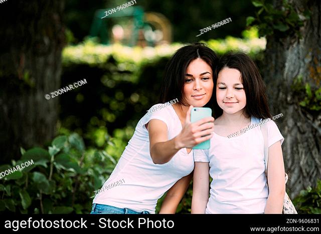Mother and daughter spend a fun time in the park park