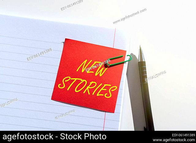 Sign displaying New Stories, Internet Concept imaginary or real showing and events told for entertainment Sticky Note With Important Idea Clipped On Opened...