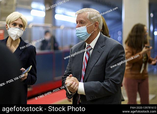 Senator Lindsey Graham, a Republican from South Carolina, wears a protective mask while walking through the Senate Subway at the U.S