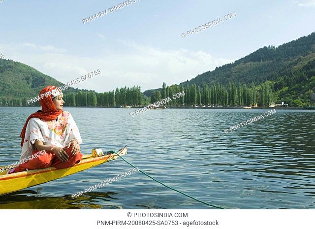 Woman sitting in a shikara, Dal Lake, Srinagar, Jammu And Kashmir, India