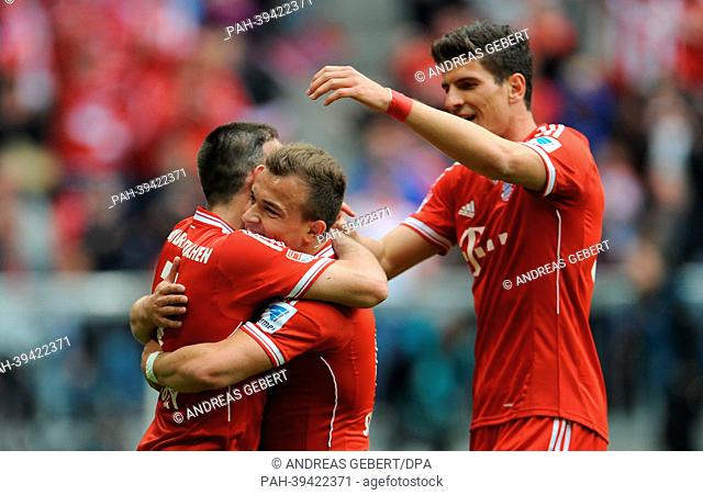 Bayern Munich's Xherdan Shaqiri (C) celebrates his 2-0 goal with teammates Franck Ribery (L) and Mario Gomez during the Bundesliga soccer match between Bayern...