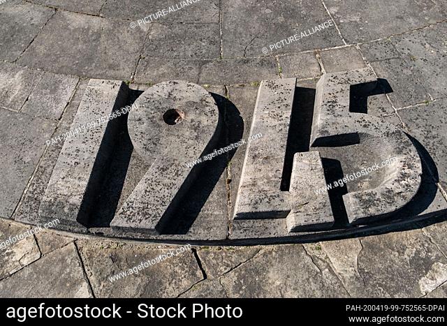19 April 2020, Lower Saxony, Bergen: The year 1945 can be seen on the floor plate of the obelisk on the inscription wall during the commemoration of the 75th...