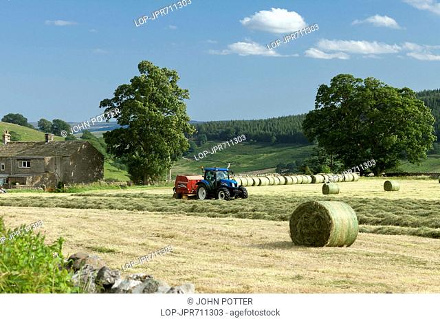 England, North Yorkshire, Burnsall. Harvesting near Burnsall in the Yorkshire Dales