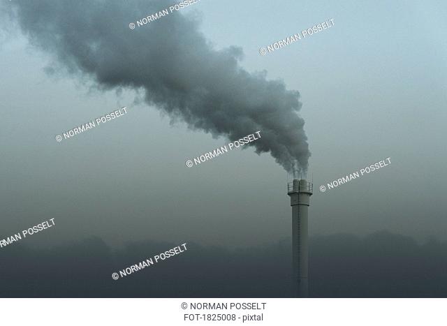 Smokestack emitting smoke, Neukoelln, Berlin, Germany