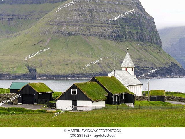 Village Vidareidi with church on the Island Vidoy. View towards Bordoy and Kunoy. Nordoyggjar (Northern Isles) in the Faroe Islands