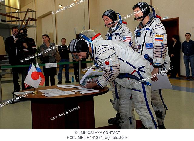 At the Gagarin Cosmonaut Training Center in Star City, Russia, Expedition 4243 backup crewmember Kimiya Yui of the Japan Aerospace Exploration Agency signs in...