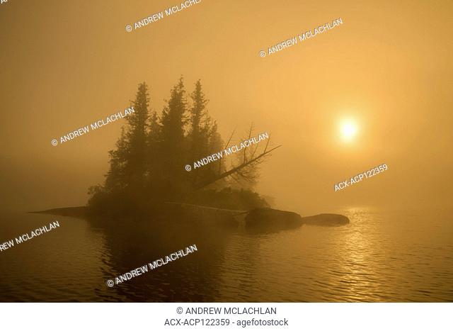 Misty sunrise over Horseshoe Lake in Muskoka near Parry Sound, Ontario, Canada