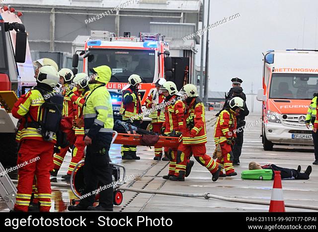 11 November 2023, Thuringia, Erfurt: Rescue workers transport extras during an emergency exercise at Erfurt-Weimar Airport