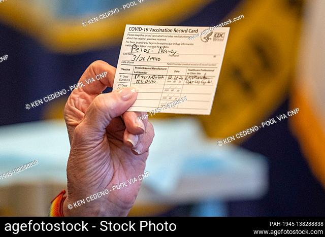 Speaker of the United States House of Representatives Nancy Pelosi (Democrat of California), holds up a Vaccination Record Card after receiving a COVID-19...