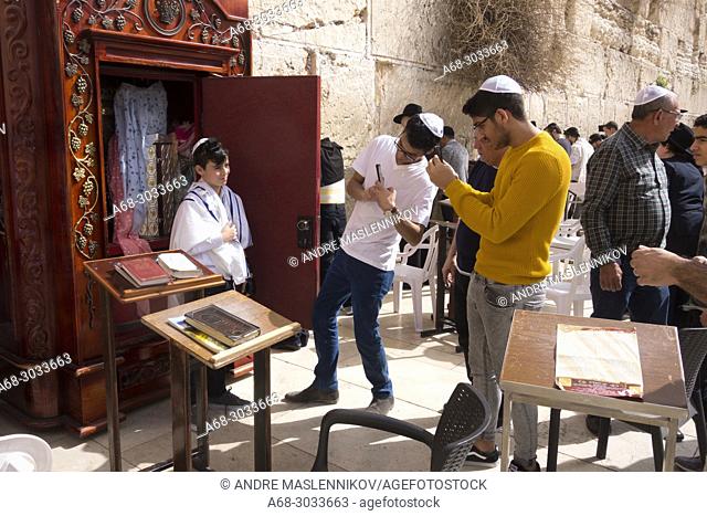 Bar Mitzvah ritual at the Western Wall, in Jerusalem. A boy who has become a Bar Mitzvah is morally and ethically responsible for his decisions and actions