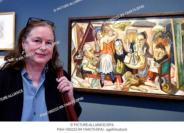 22 February 2018, Germany, Potsdam: Mayen Beckmann (R), grandchild of the painter Max Beckmann, stands in front of the painting 'Familienbild' (1920) (lit