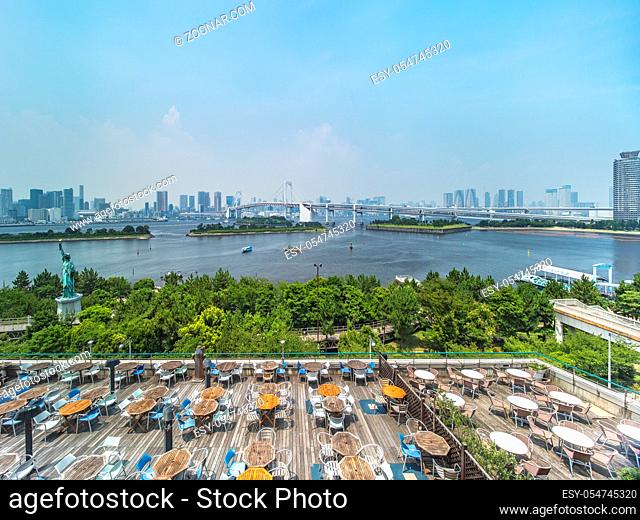 View of the bay of Odaiba with daiba park, Statue of Liberty and Rainbow Bridge