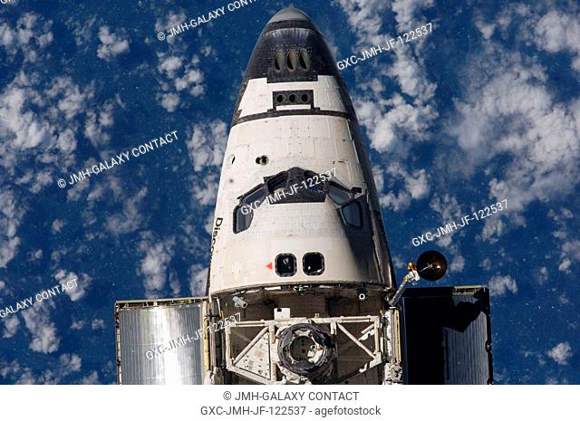 An overhead close-up view of the exterior of Space Shuttle Discovery's crew cabin, part of its payload bay and docking system was provided by Expedition 18...