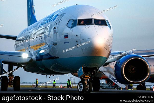 RUSSIA, OMSK - JULY 17, 2023: A pilot of a Boeing 737-800 plane of Pobeda waves his hand at Omsk Central International Airport named after Dmitry Karbyshev...