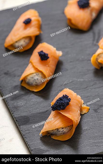 smoked salmon rolls filled with cream cheese and black caviar