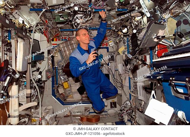 Astronaut Clay Anderson, Expedition 15 flight engineer, uses a communication system in the Destiny laboratory of the International Space Station