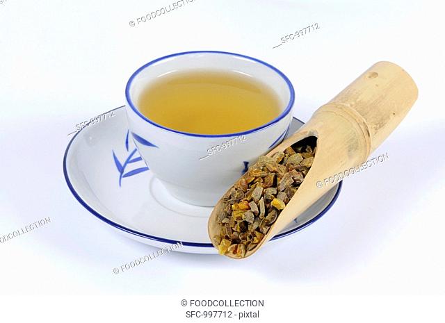 Turmeric root with a cup of tea