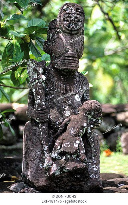 Weather beaten statue made of stone, Tiki in the village of Hatiheu on the island of Nuku Hiva, French Polynesia