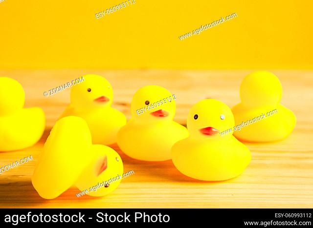 Yellow rubber duck doll on wooden table