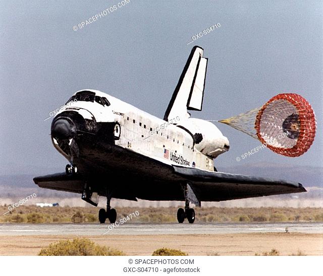 With its drag parachute deployed to help slow it down, the Space Shuttle Discovery rolls down the runway after landing at Edwards Air Force Base in Southern...