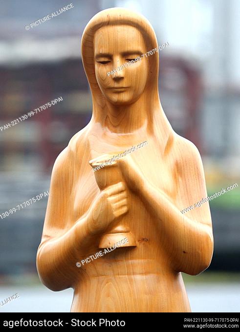 PRODUCTION - 29 November 2022, North Rhine-Westphalia, Cologne: The wooden statue of St. Barbara stands in the entrance area of the RAG at the Zollverein...