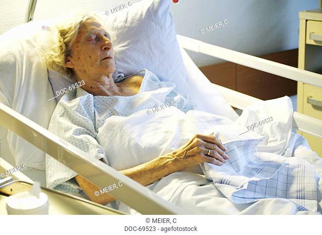 Elderly woman sleeps in a sickbed