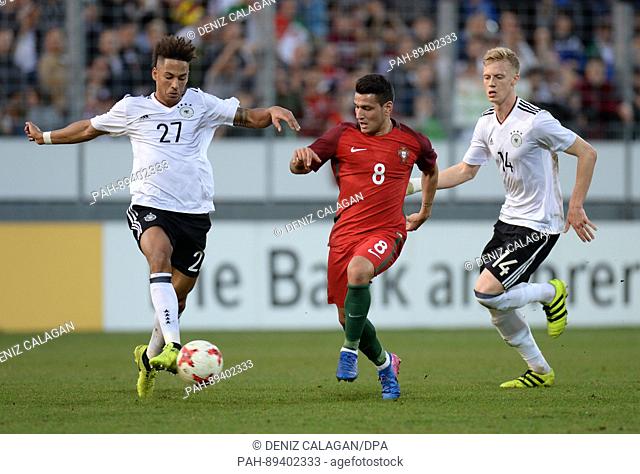 Portugal's Rony Lopes (C) and Germany's Thilo Kehrer (L) and Timo Baumgartl, vie for the ball during the U-21 international friendly soccer match between...